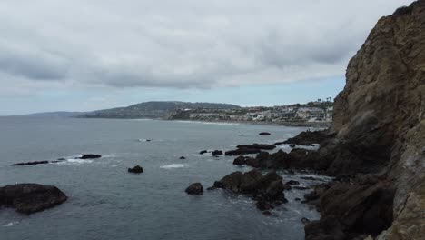 Aerial-Flight-Along-The-Rocky-Sea-Cliffs-Of-Pirate's-Cave-In-Dana-Point,-California