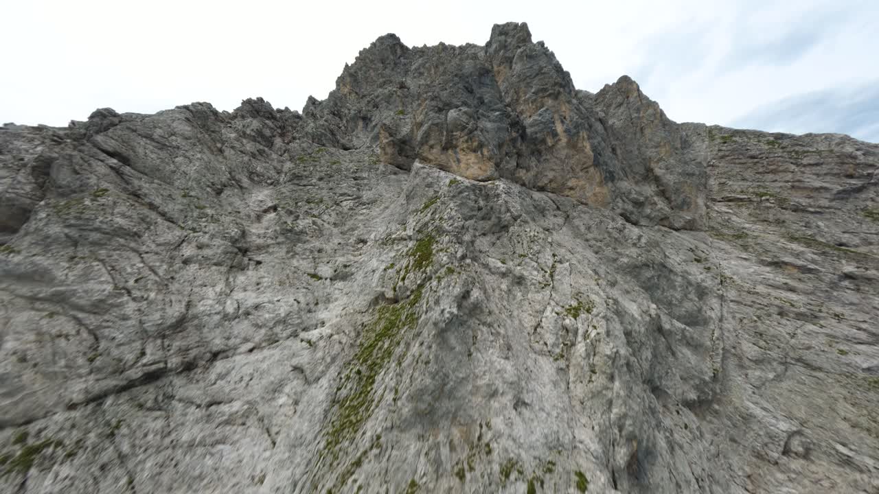 drone fpv llegando a la cima de una montaña rocosa empinada en el tirol, austria