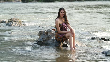 woman in traditional clothing by a river