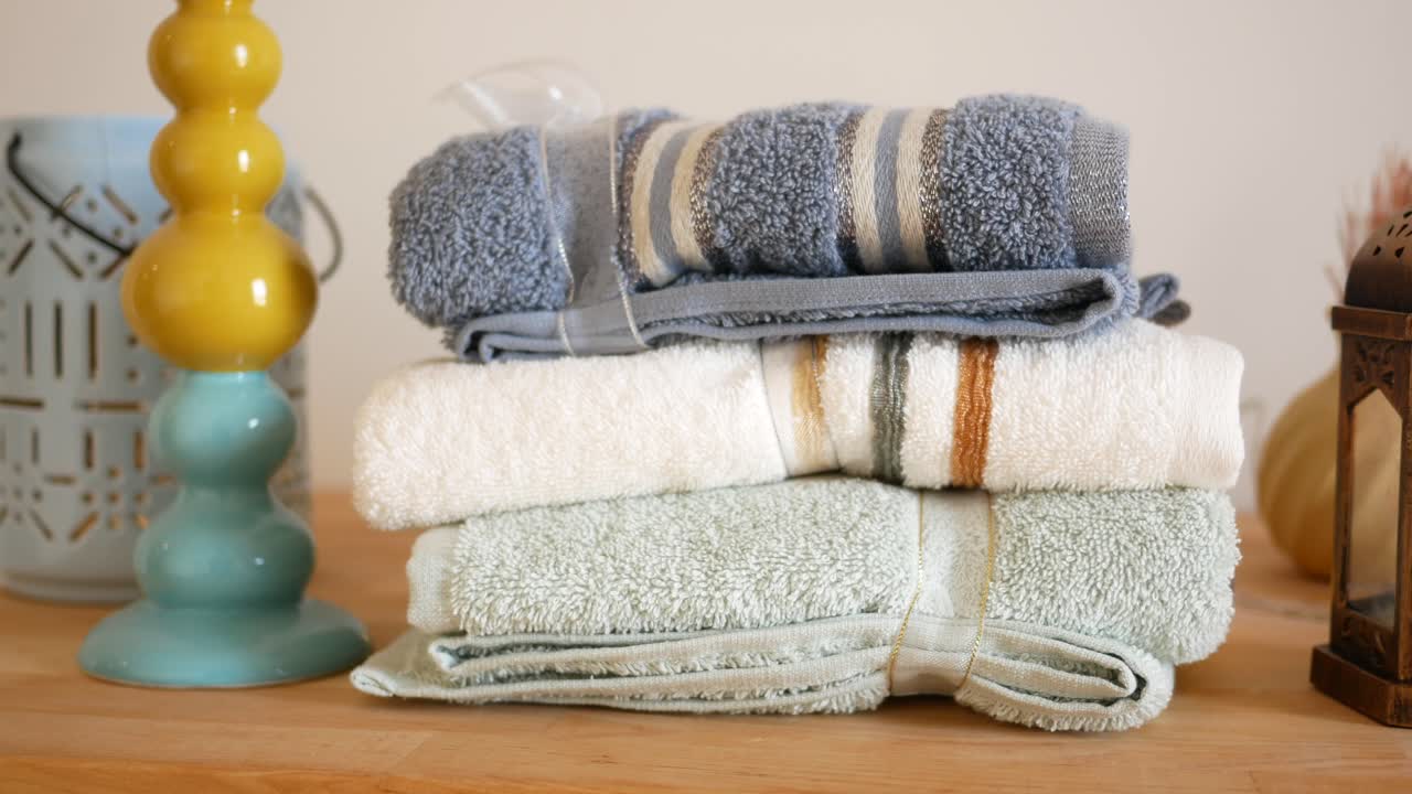 Stacked Towels and Decorative Items on a Wooden Table
