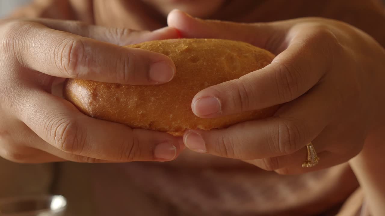 Hands Breaking a Freshly Baked Bread Loaf