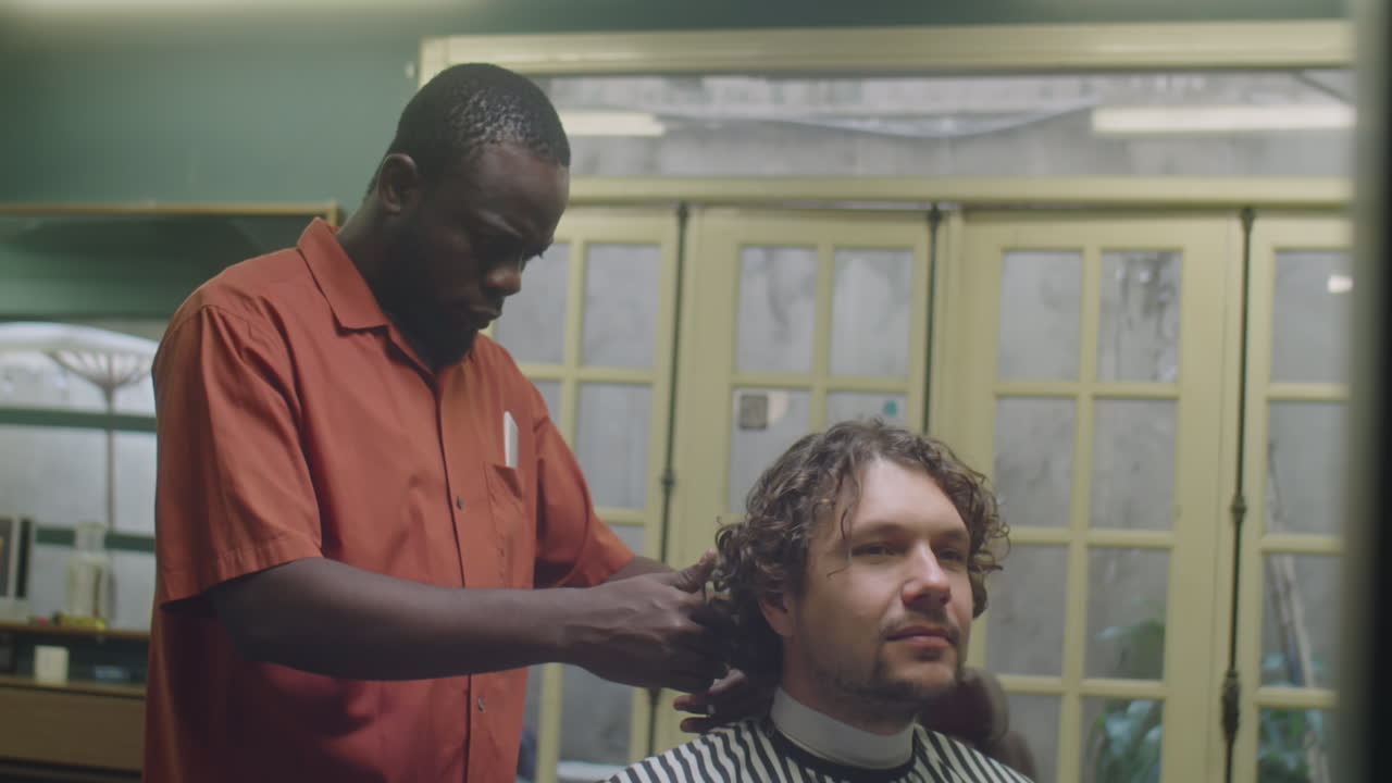 Male Client Speaking with Barber Doing Him Haircut