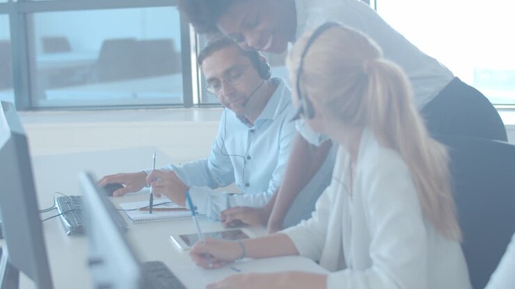 Friendly female manager with tablet, explaining tasks to employees
