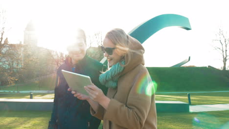 Man-and-woman-walking-and-using-tablet-PC