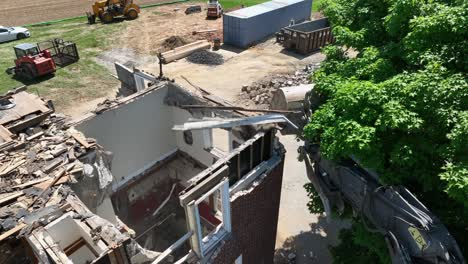 demolition of a brick building using heavy machinery