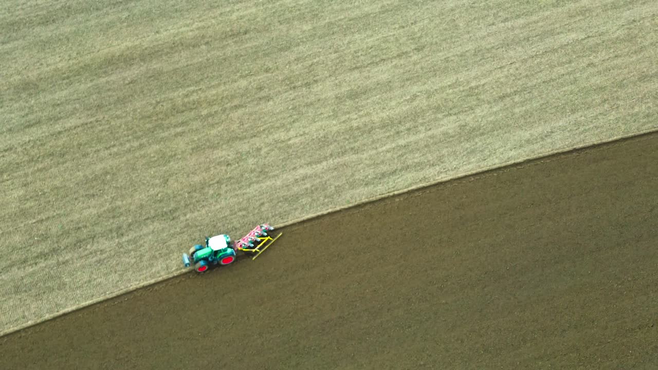 drone fly over field plowing tractor 4k