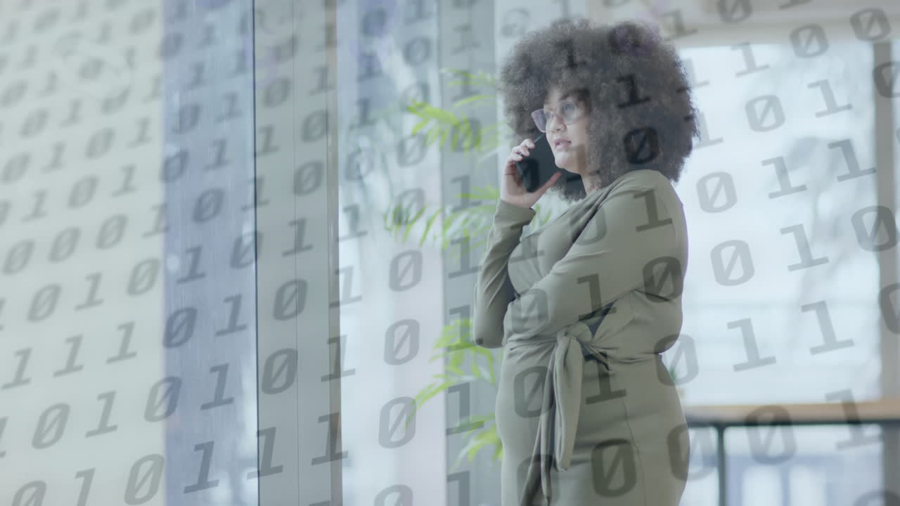 Animation of binary coding data processing over biracial businesswoman in office