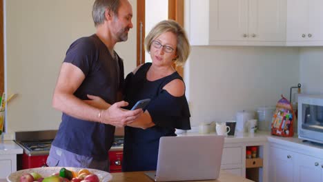 Couple-embracing-each-other-in-kitchen-4k