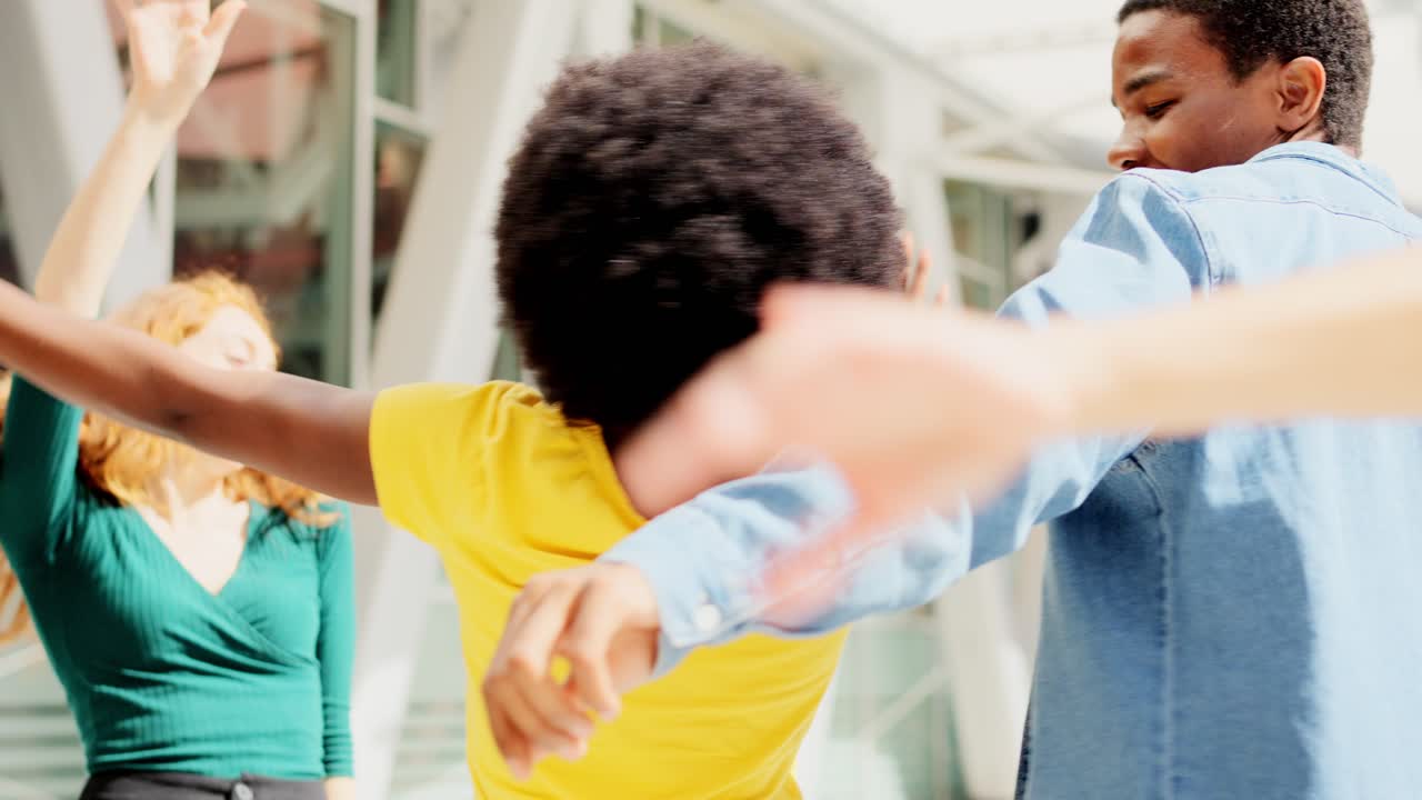 Diverse Young Adults Dancing and Interacting in an Urban Setting