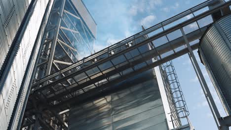 industrial grain silos and structures against a blue sky