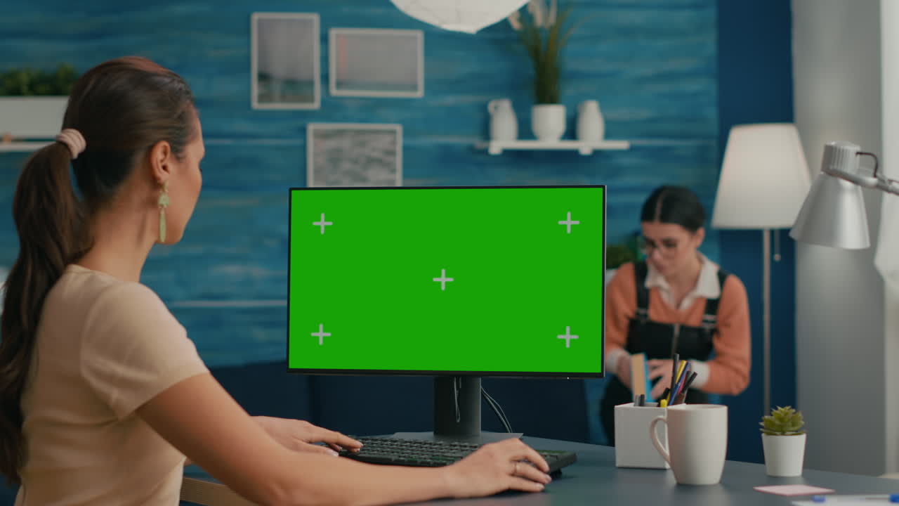 Freelancer searching the internet on green screen chroma key display