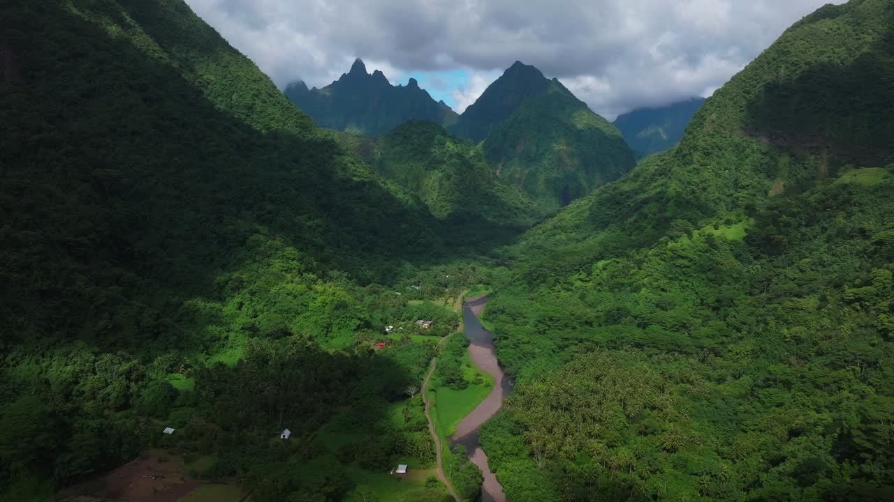 Vallee de Tautira River Valley Bay Vaitepiha village Tahiti island French Polynesia aerial drone jagged mountain peaks canyon ravine Mount Aorai Taiarapu Taravao North Shore sunny clouds forward