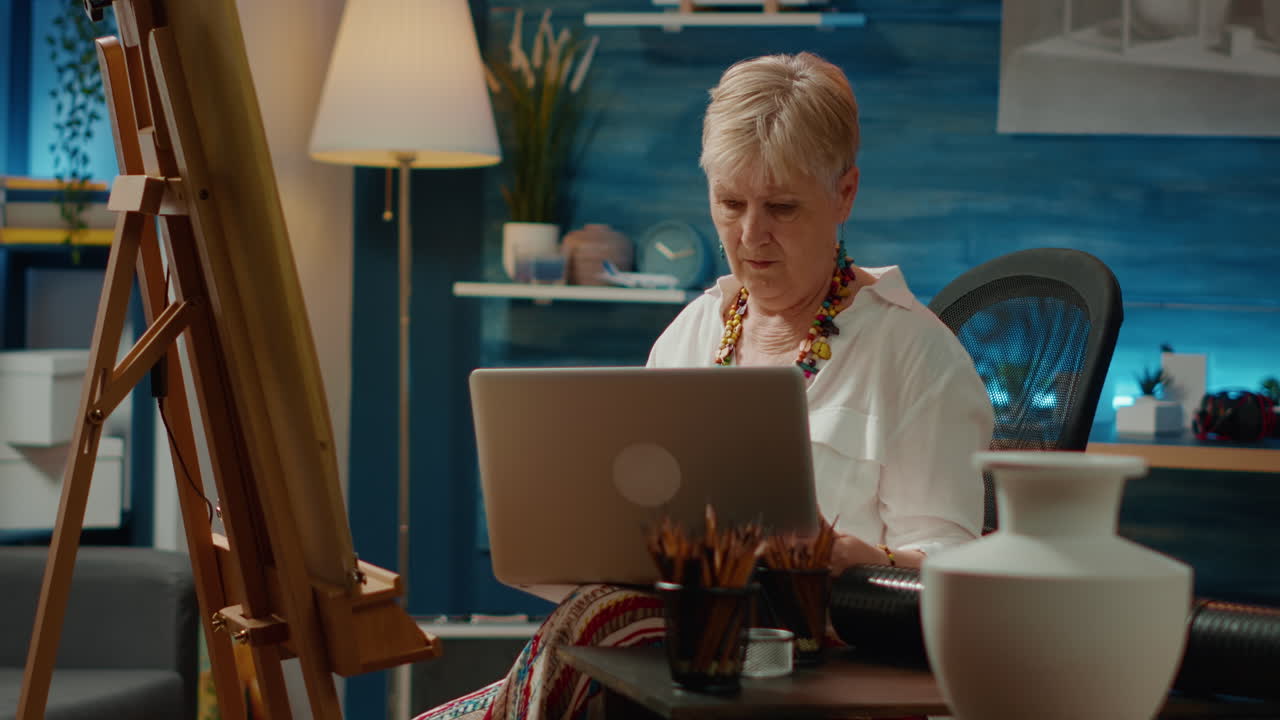 Retired artist finding drawing inspiration online on laptop