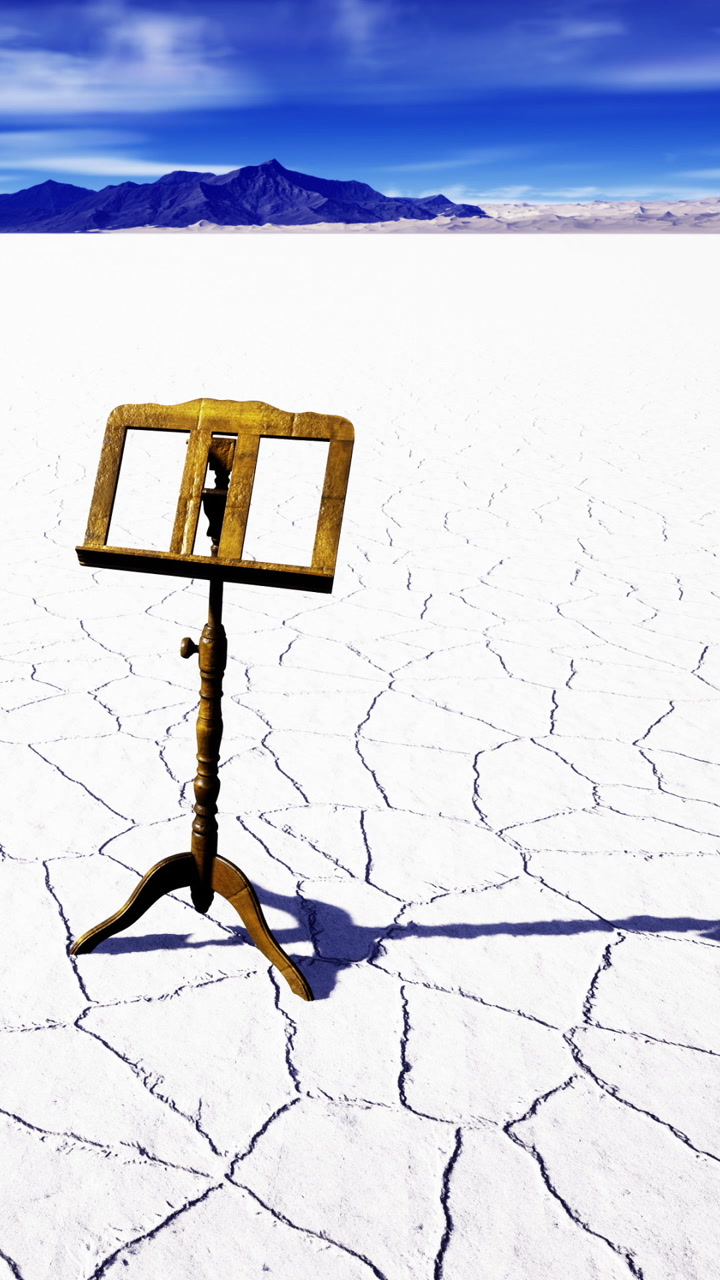 Musical stand in salt flat with mountains in background during daytime