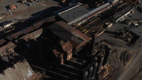 old steel mill complete with smokestack and huge boilers