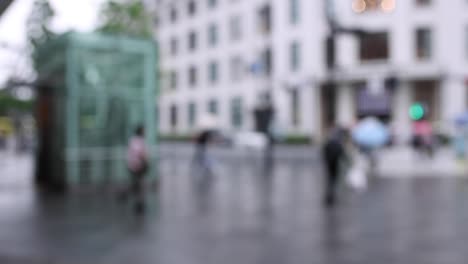 walking people on the street in marunouchi tokyo rainy day