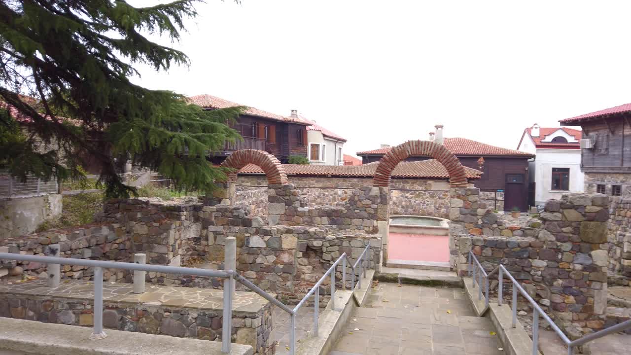 Ancient remains of medieval church with basilica in old town Sozopol, Bulgaria. Arches and stone walls. Marble architectural columns. Pan left.