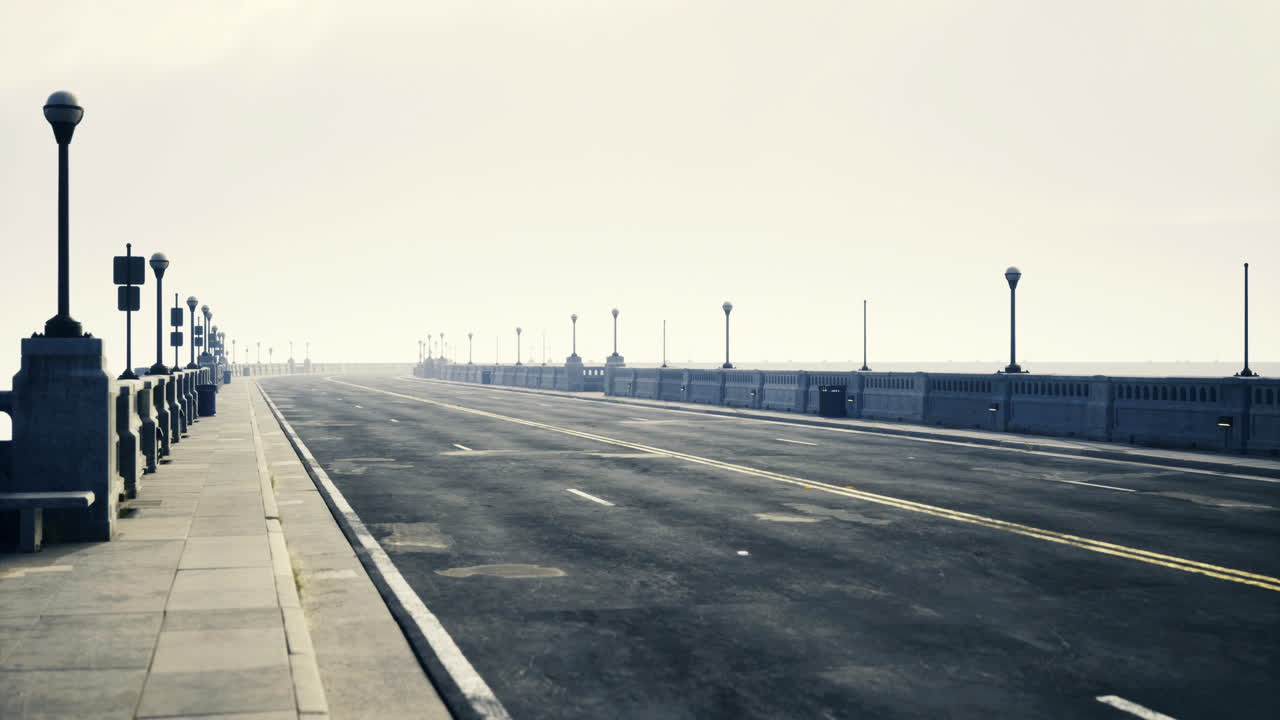 Long empty road leading to the horizon in a foggy coastal setting
