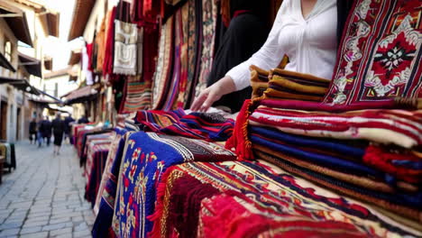 woman selling handmade rugs in a street market