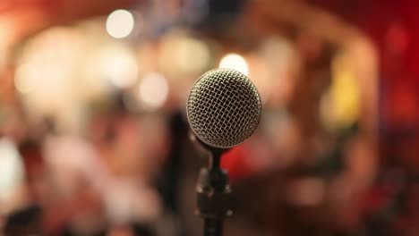 Microphone-on-stage-against-a-background-of-auditorium.