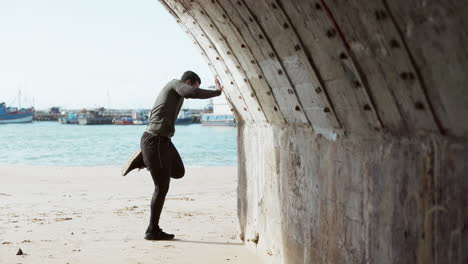 beach, fitness and black man stretching