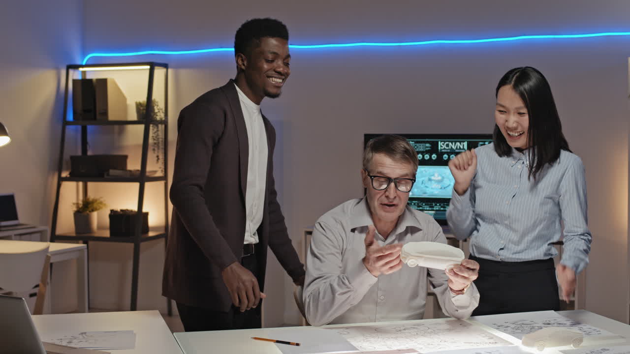 Engineers Working on Prototype and High-Fiving