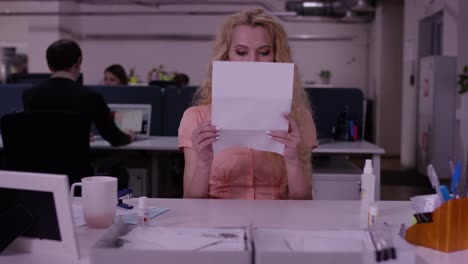 woman reading documents in office