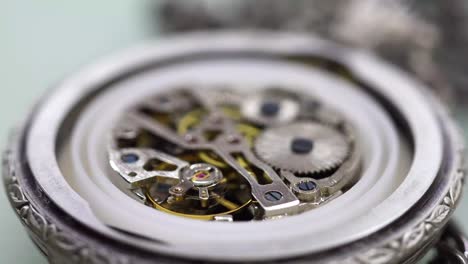 old pocket watch mechanism working, close up view