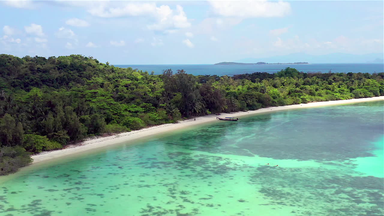 Tropical island Aerial view. Camera flies over the shore and the beach of the tropical island