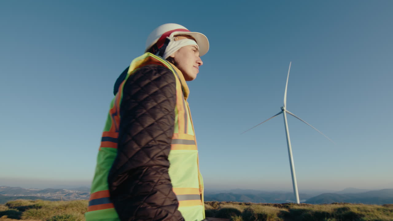 Female Engineer Going to Work at Wind Farm in the Morning