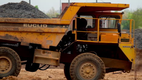 heavy yellow dumper trucks. heavy mining dump truck in limestone quarry
