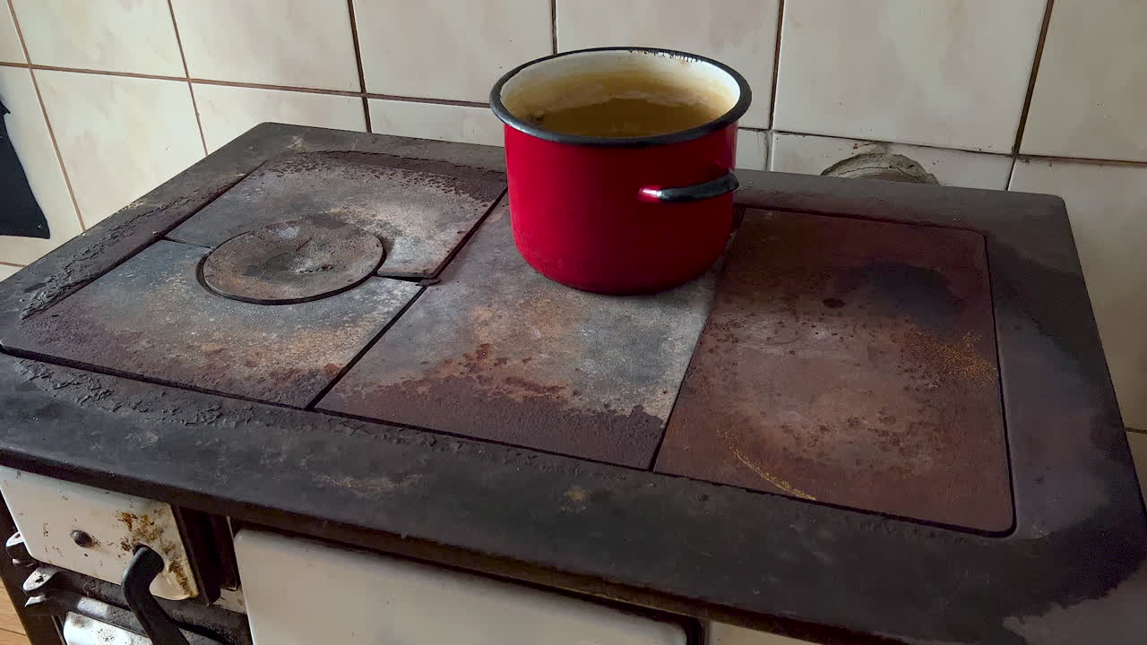 Cooking Pot On The Vintage And Rusty Stove In The Kitchen