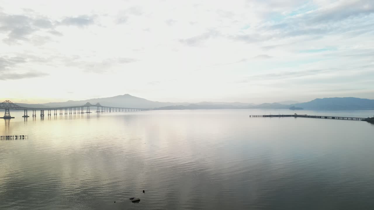 Bright sunset light above serene Richmond Bridge from Point Molate Beach Richmond California USA