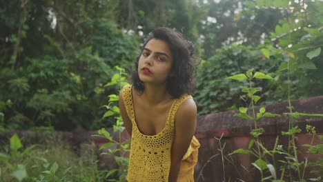 a young beautiful girl in a yellow crochet outfit with short hairs leaning in