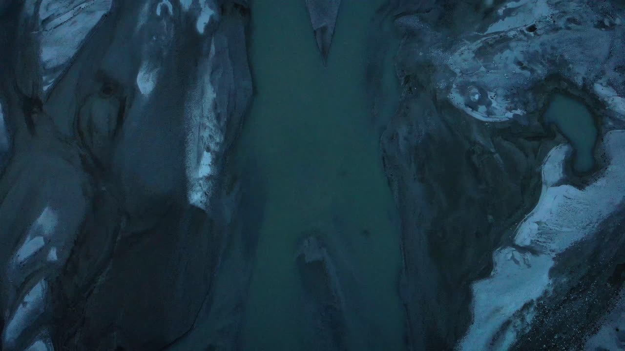 Aerial flyover with pan up revealing Forno glacier in Engadin, Switzerland shortly before sunset