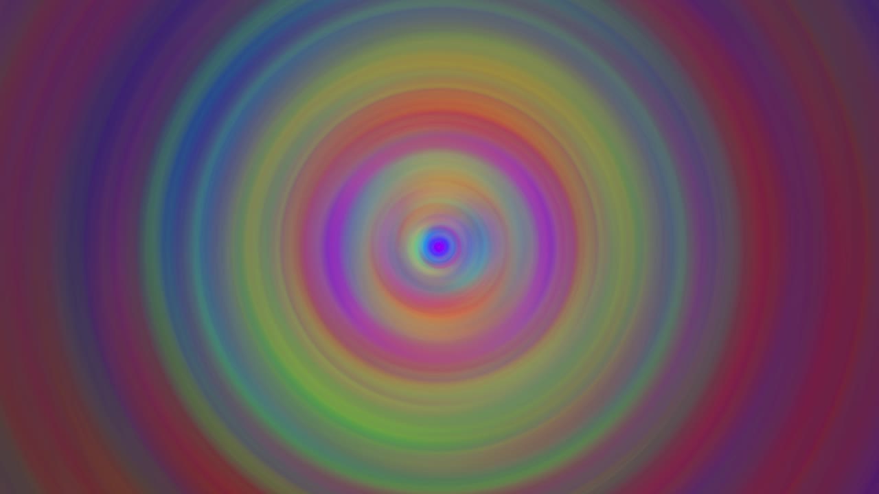 Whirling rotating blurred whirlpool creates hypnotic concentric circles of vibrant rainbow colors
