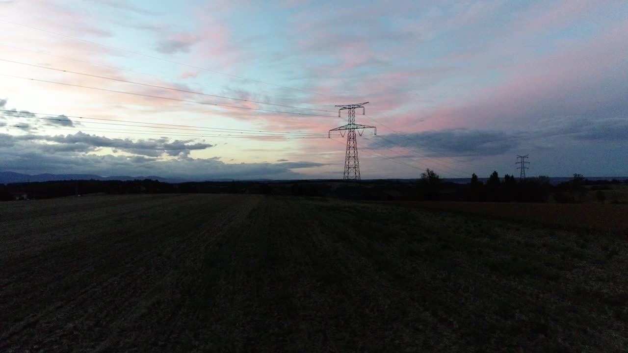 Cinematic drone footage of a power pole and sunset outdoors