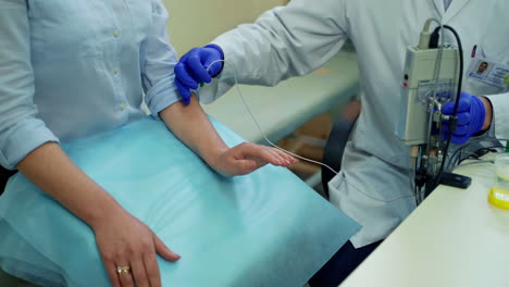 male doctor examining young woman. young doctor treating female patient in hospital