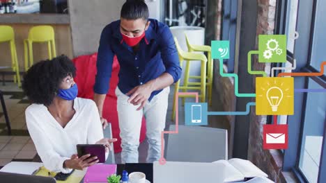 video compuesto de la red de iconos digitales contra diversos colegas de oficina discutiendo en la oficina