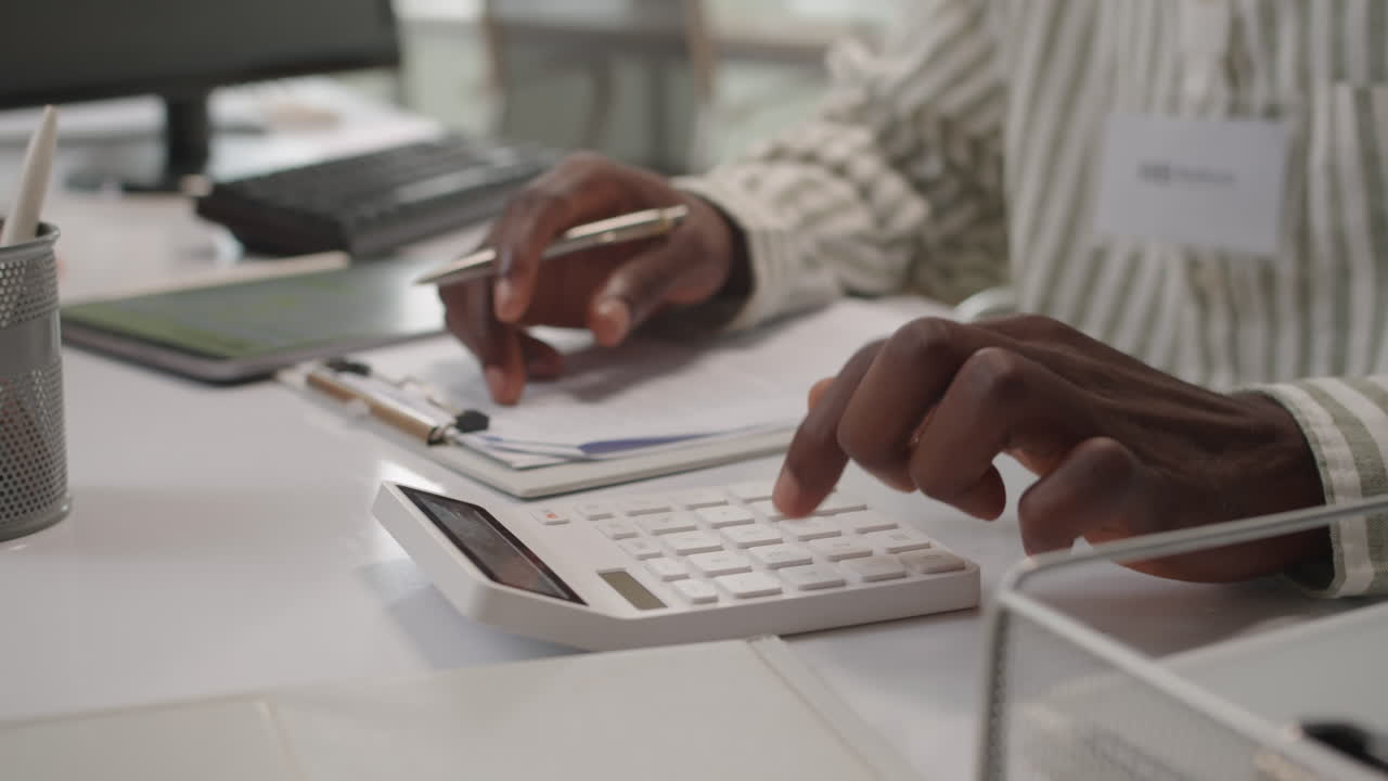 Hands of Bank Specialist Calculating Down Payment Amount for Clients Loan