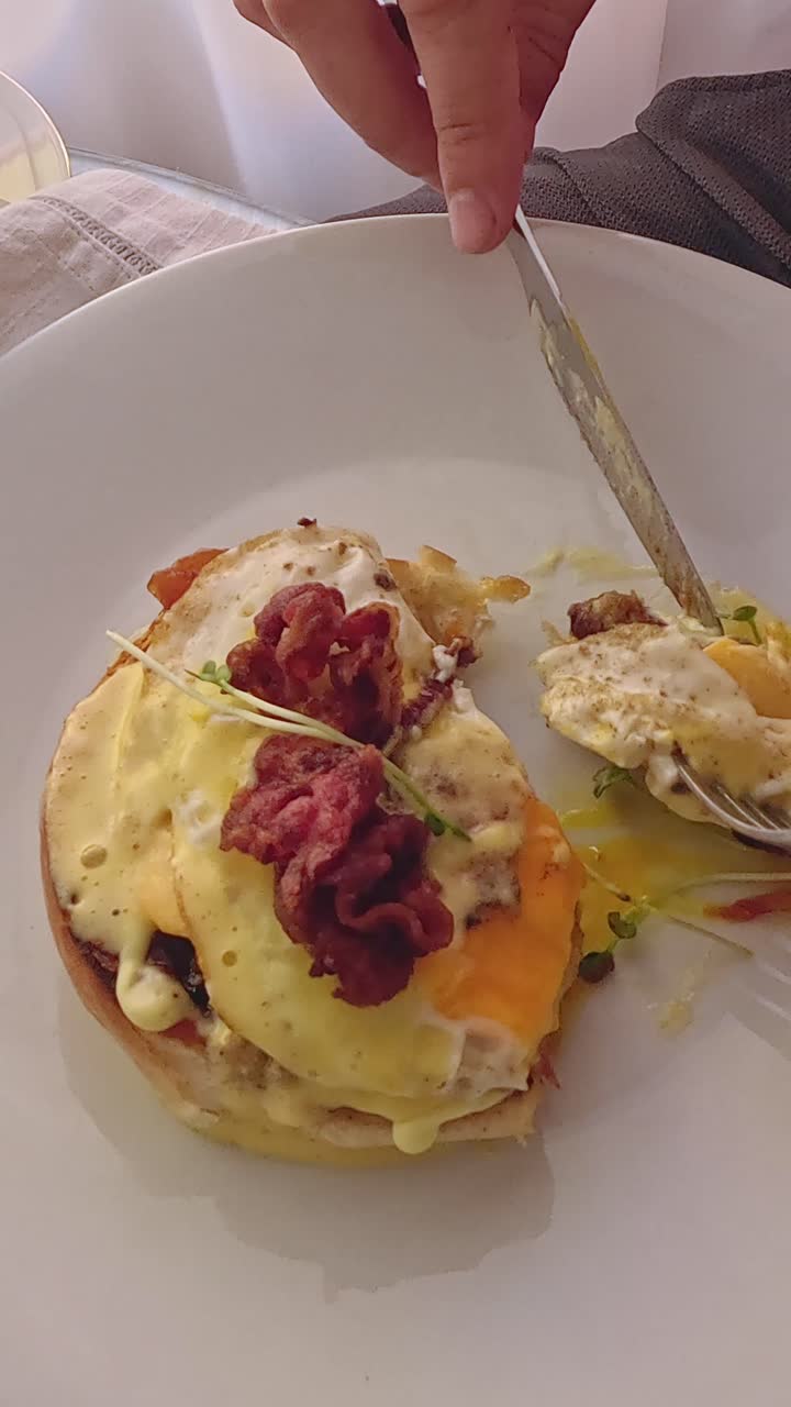 Overhead view eating croque monsieur showing eggs and creamy sauce, a popular french dish for breakfast
