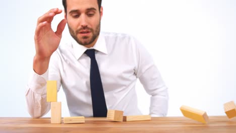 businessman playing with building blocks