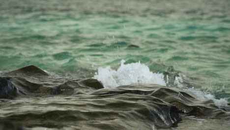 splash of ocean water on rocks creating beautiful patterns, slow motion