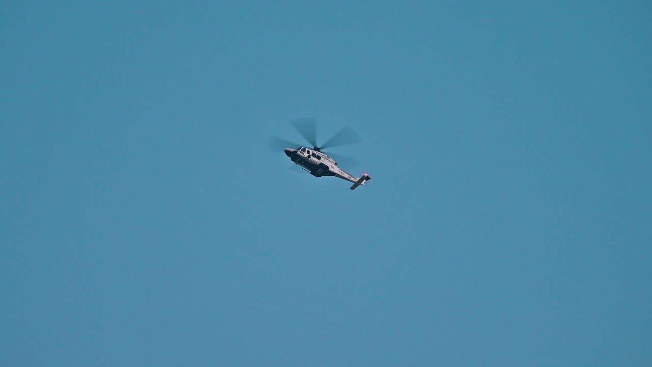 A Dubai Police helicopter patrolling over the city of Dubai