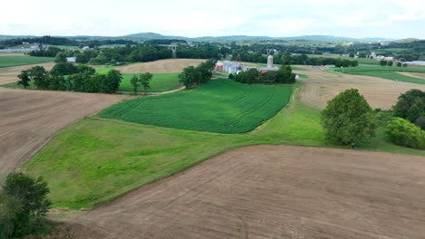 A-serene-American-landscape,-green-fields,-silos-stand-tall