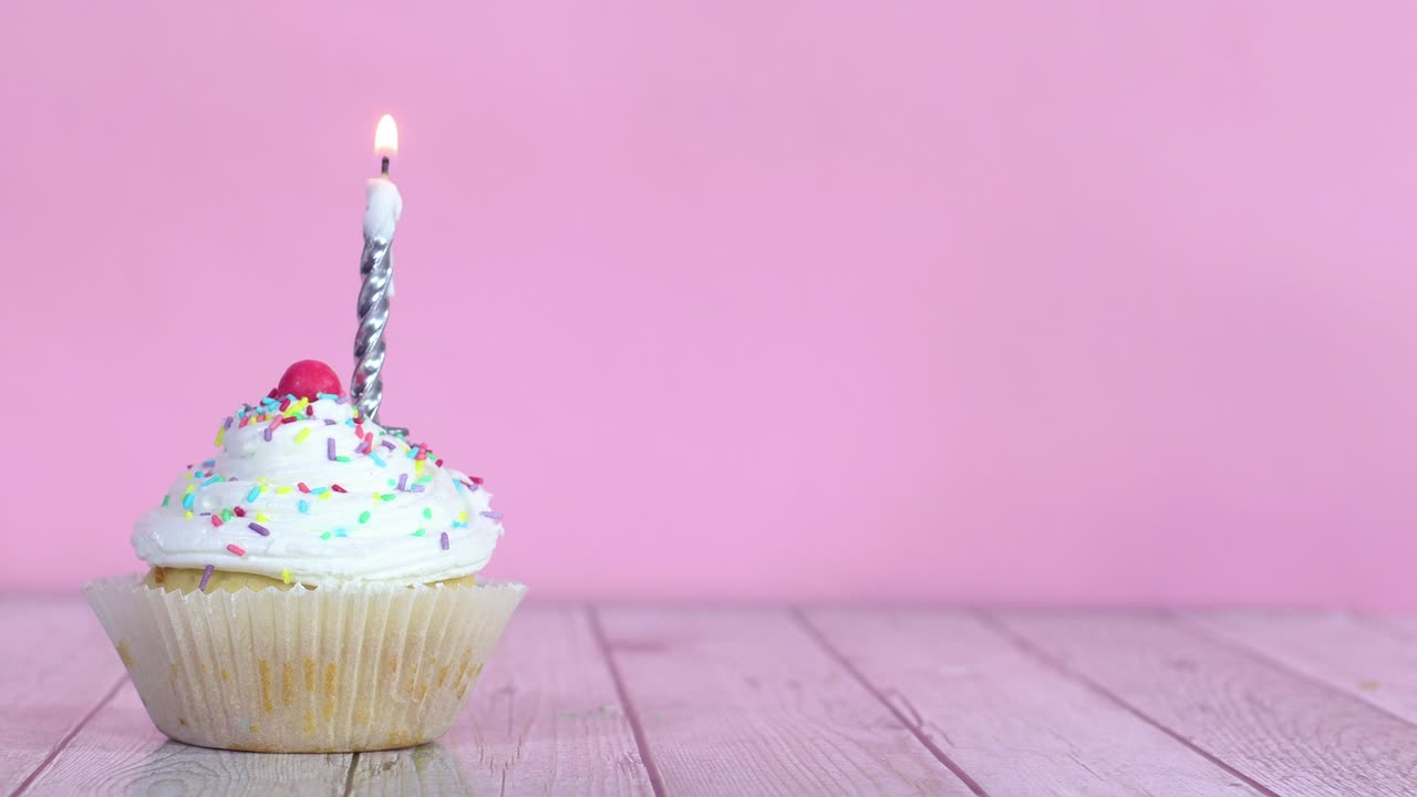 Lighting up candle on sweet testy cup cake with cream