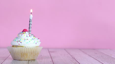 lighting up candle on sweet testy cup cake with cream