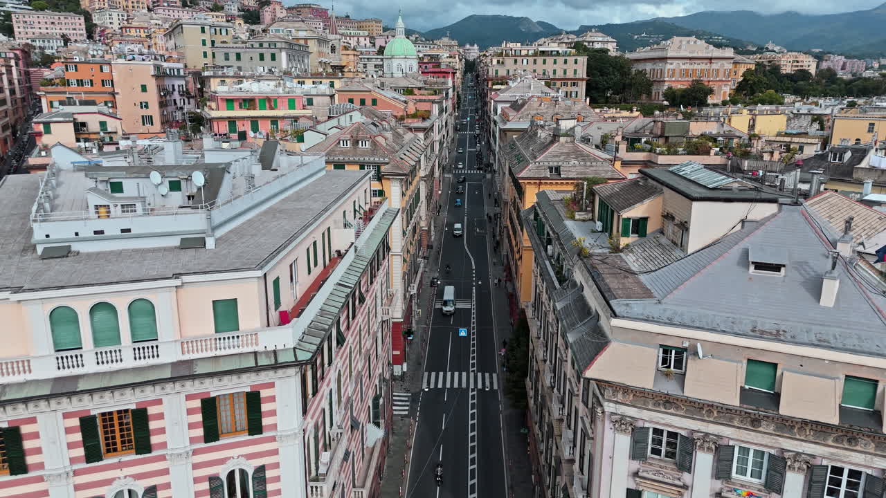 Traffic flow down Via Assarotti in historic center of Genoa, Italy. Aerial