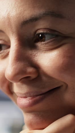 vertical video extreme close up of smiling programmer monitoring server clusters