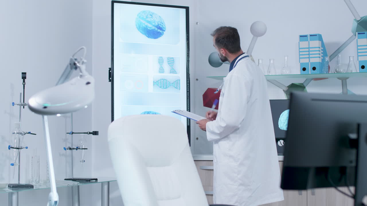 Doctor Analyzing Medical Data on a Monitor